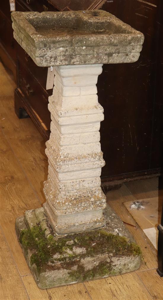 A reconstituted stone garden bird bath H.84cm